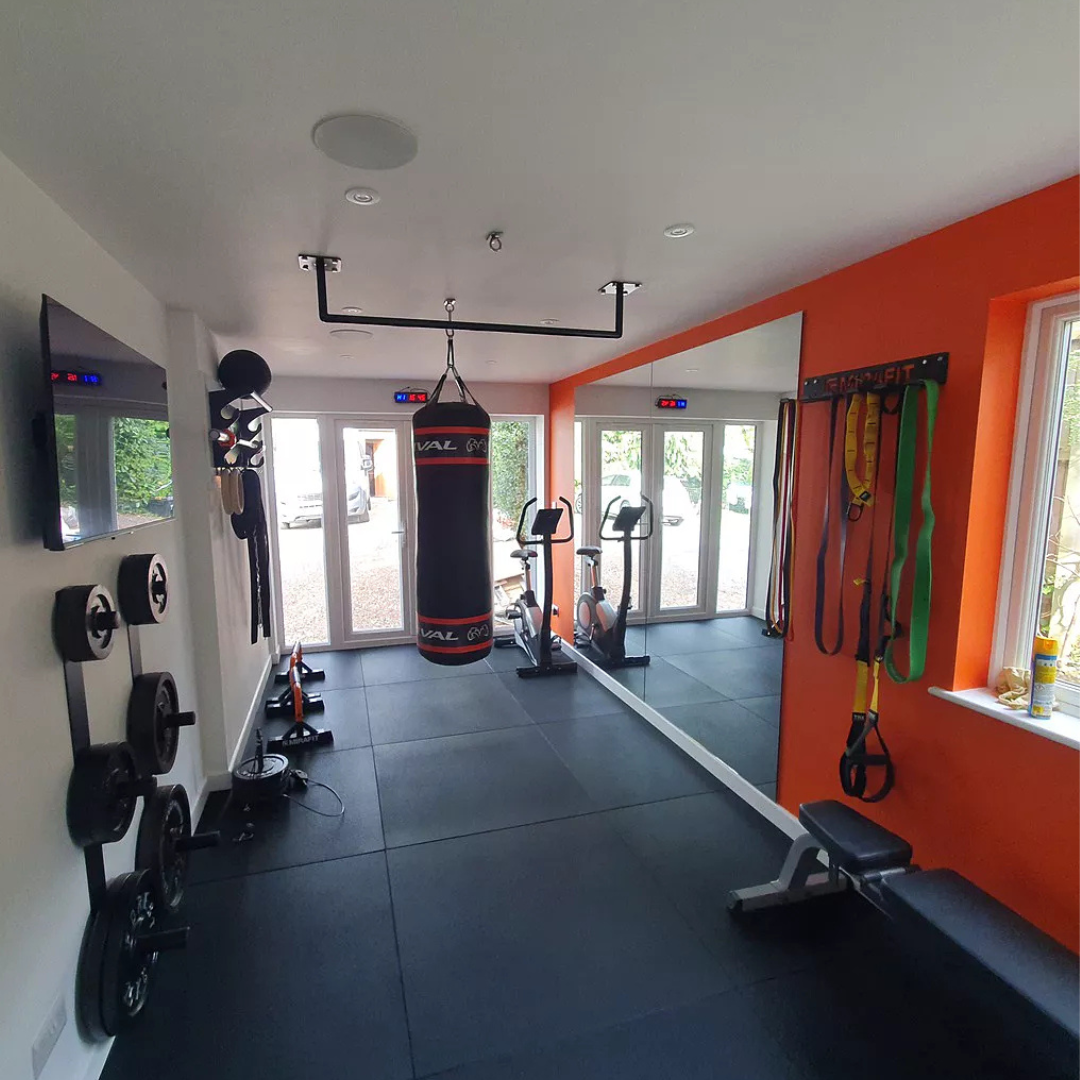 Garage home gym with punch bag and mirror on black 20mm PRO rubber gym tiles