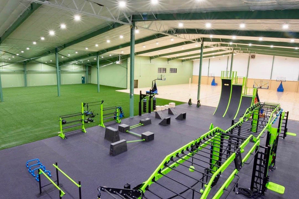 Create a fun and functional gym space that incorporates elements of parkour, CrossFit, and agility training