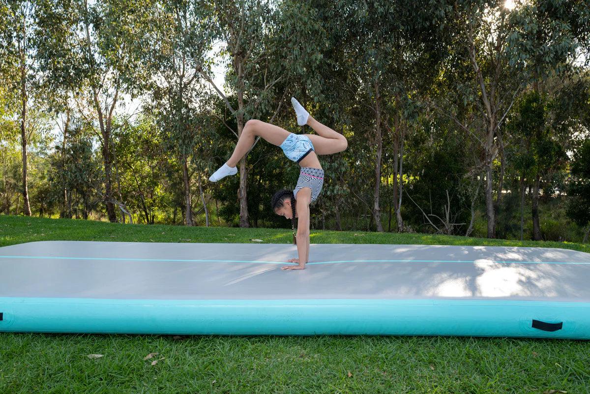 Image of a child doing gymnastics on the air track